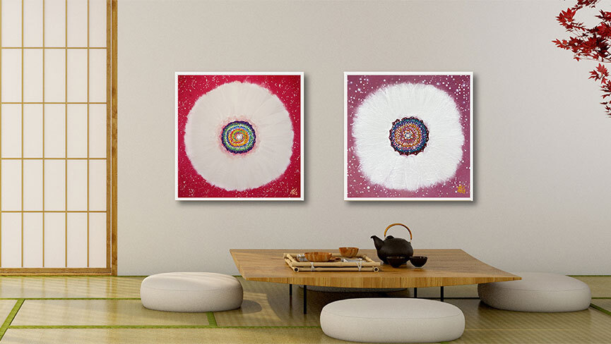 Paintings from Jisu Han's Flower of the Universe series sit on the wall of an Asian-themed room with a low table and cusion
